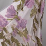 Purple Tulle fabric with beautifully embroidered flowers, adding a touch of delicate elegance