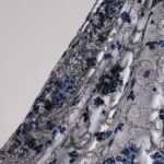 White and blue Tulle fabric featuring floral embroidery