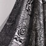 Black tulle fabric featuring floral embroidery