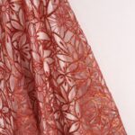 Red Tulle adorned with embroidery