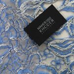 Blue Tulle fabric adorned with enormous and tiny floral embroidery
