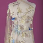 Beige Tulle with light yellow and blue floral embroidery