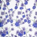Ebony Tulle adorned with purple and blue floral embroidery