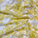 Vibrant yellow tulle fabric adorned with intricate floral embroidery