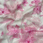 Pink tulle fabric with floral embroidery and subtle sequins