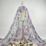 Tulle fabric with beautifully embroidered flowers, adding a touch of delicate elegance