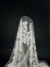 Off White Tulle with appliquéd flowers and pearl centers for a touch of elegance