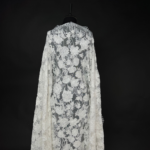Lace fabric with intricate embroidery and subtle sequins for a refined, elegant touch