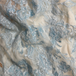 Baby Blue Lace fabric with intricate embroidery and subtle sequins for a refined, elegant touch