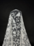 Tulle with intricate embroidery and shimmering sequins