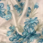 Baby blue Harmony Tulle adorned with floral embroidery