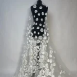 Sheer off white tulle with jacquard appliqué and subtle sequin sparkle.