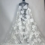 Off white tulle with delicate embroidery, subtle sequins, and 3D jacquard flowers with sequin accents
