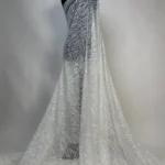 Glamorous off white tulle with shimmering leaf-patterned sequins and beads