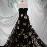 Black tulle with delicate embroidery, subtle sequins, and 3D jacquard golden flowers with sequin accents.