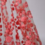 Coral tulle adorned with embroidery