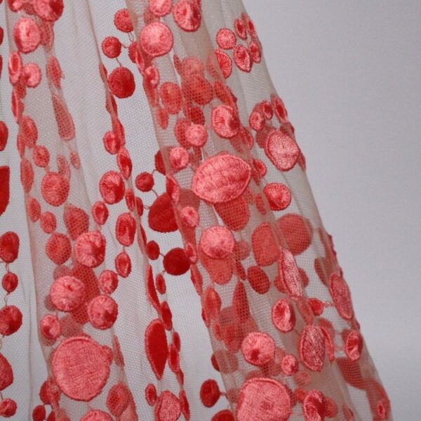 Coral tulle adorned with embroidery