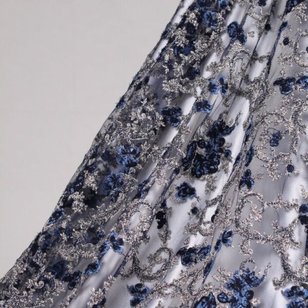 White and blue Tulle fabric featuring floral embroidery