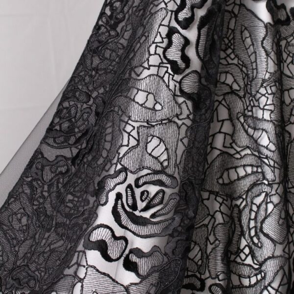 Black tulle fabric featuring floral embroidery