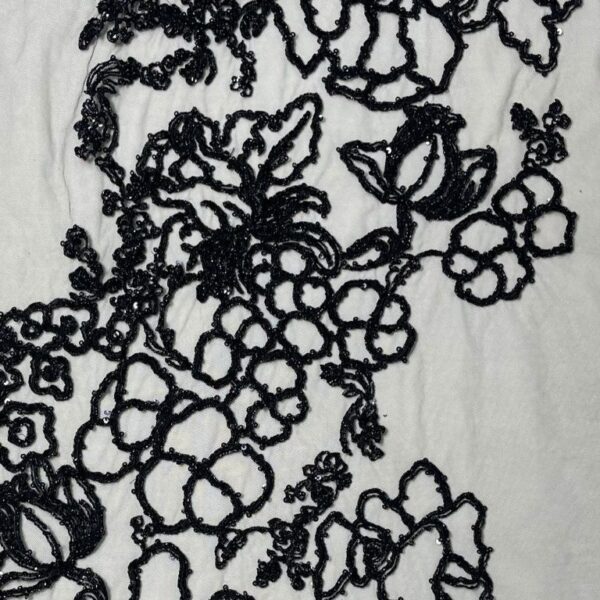 Black Tulle fabric adorned with floral embroidery