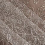 White tulle adorned with floral embroidery