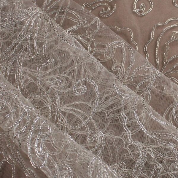 White tulle adorned with floral embroidery