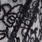 Black Tulle fabric adorned with floral embroidery