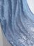 Blue tulle adorned with shiny embroidery
