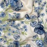 Vibrant blue tulle fabric adorned with intricate floral embroidery