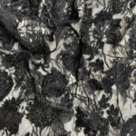 Black fabric with intricate embroidery and subtle sequins for a refined, elegant touch